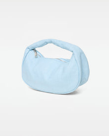 Angled view of the Mendoza Bag in sky blue showing the woven texture, silver zipper closure, and curved handle.