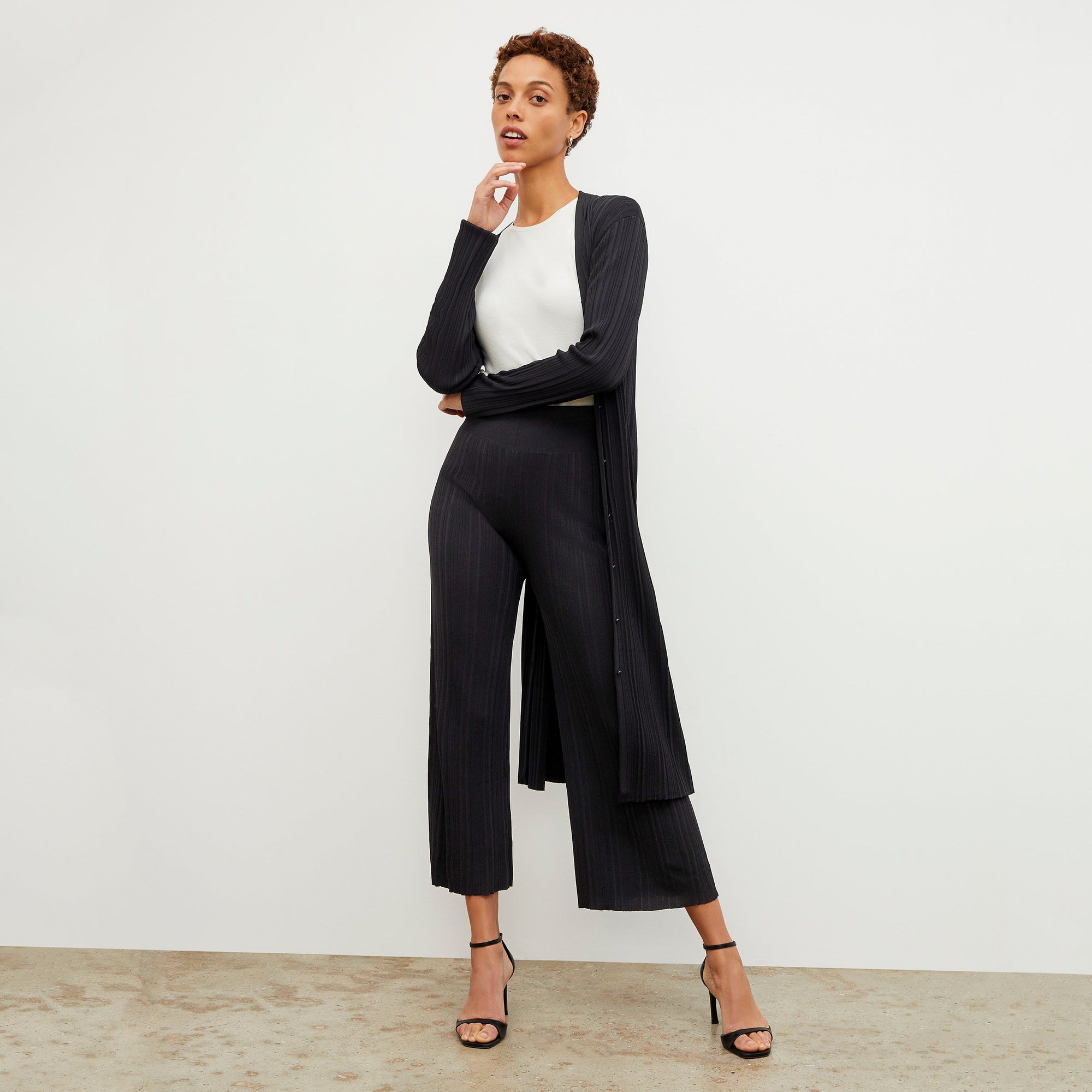 Front image of a woman wearing the Marijane Pant - Textured Knit in Black | Exclude