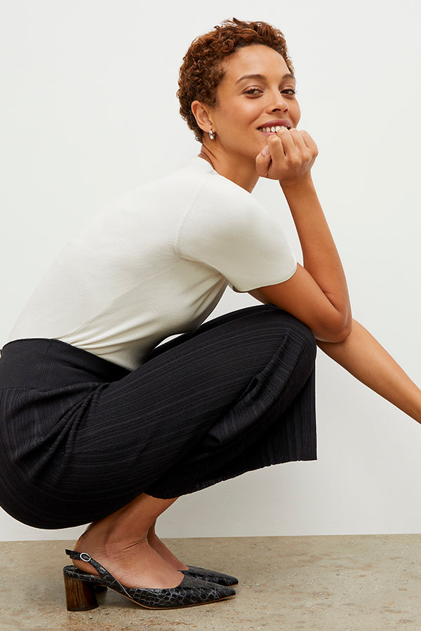 Side image of a woman wearing the Marijane Pant - Textured Knit in Black | Exclude