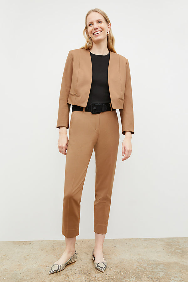 Front image of a woman standing wearing the Neale jacket in camel | Exclude