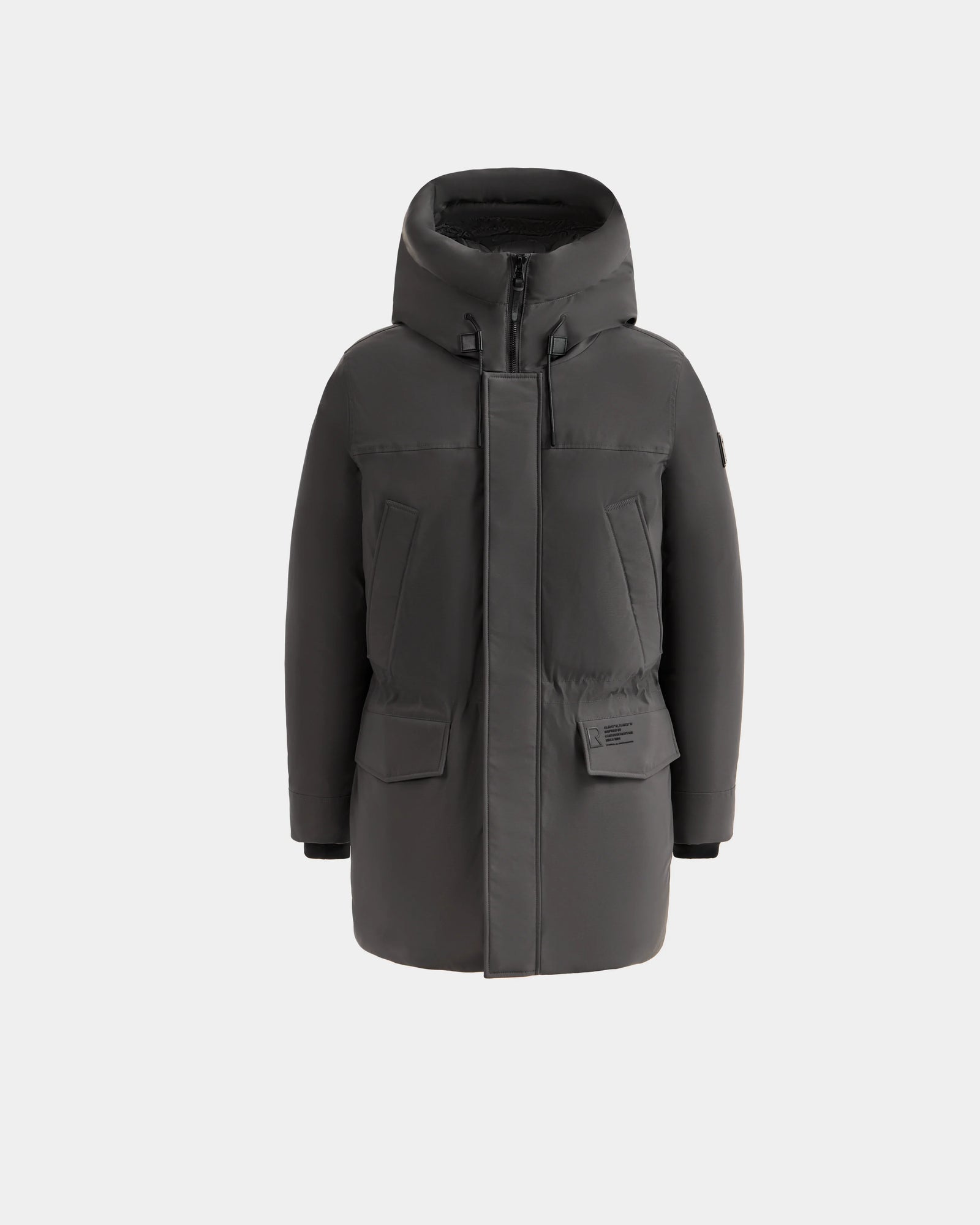 The Rudsak MITCHELL - M125513 Grey is a long, dark gray men’s down parka with a high padded hood, front zipper closure, and large flap pockets—made with RDS-certified down and shown on a plain white background.