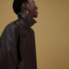 woman wearing the nicky jacket in brown
