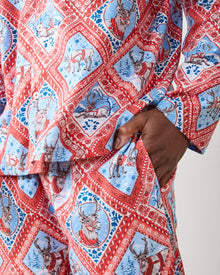 Close-up of Reindeer Games pajama set showing framed reindeer print, white buttons, and pants pocket