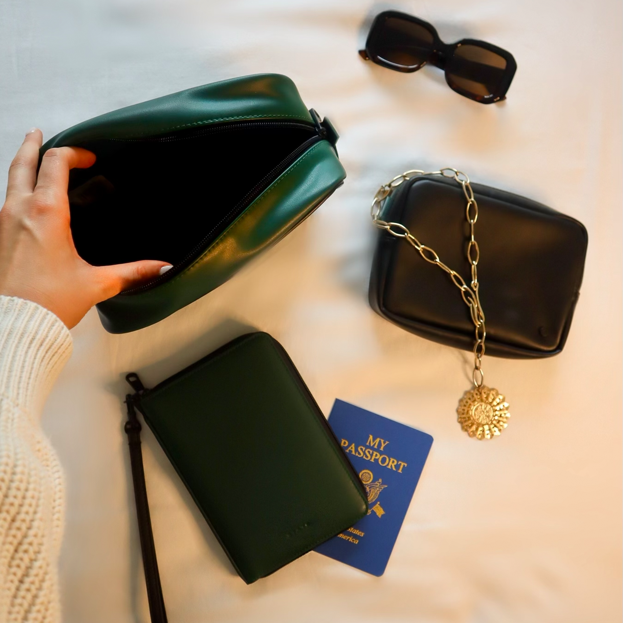 Girl opening STATE Bags Pouch in Green 