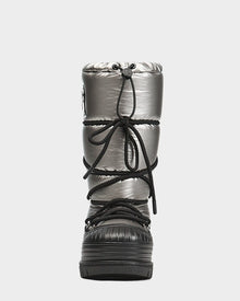 Front view of Rudsaks TISH - L223508 Pewter: a shiny metallic silver womens winter boot with black crisscross laces and a thick, textured platform sole.