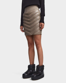 A woman wearing the MARZI - 8523528 Cement chevron quilted winter skirt by Rudsak and boots.