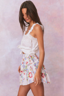 White floral tiered ruffle skirt with red, green, and blue accents with elastic waistband and double lined.