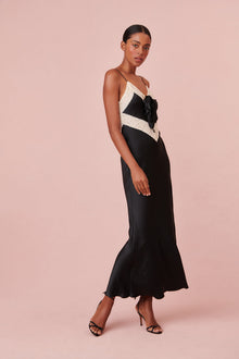  Slip dress features lace at the neckline and the waist with removable rosette pin at center front.