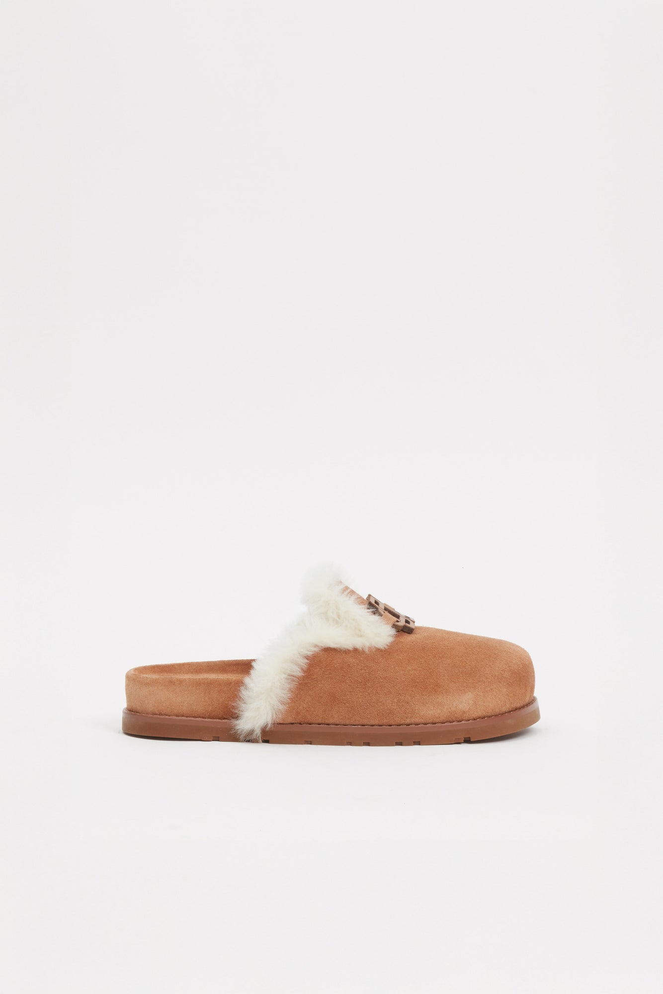 Tan suede slide with white shearling lining across the upper front and a brown rubber sole.