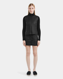 A woman in a black Rudsak LOUISE - 8124046 lightweight quilted jacket with RDS-certified down.