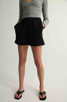 Woman wearing black sweatshorts
