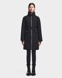 A woman faces forward against a plain white background, wearing the RUDSAK MILENA - 8122536 BLACK women’s winter coat with a high collar, paired with black pants and black boots.