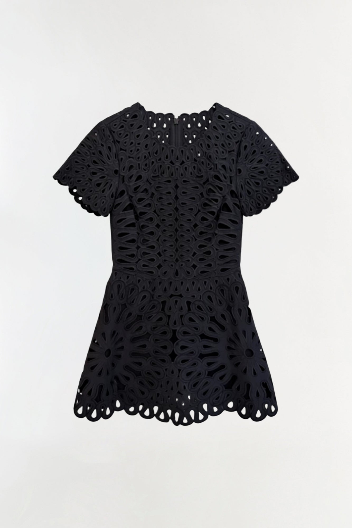 Black mini dress with short puffed sleeves and all-over eyelet embroidery pattern with scalloped hem.