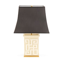 Table lamp with a black shade and decorative base on a white background